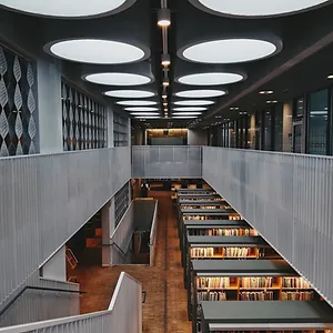 Image of a two-story library with rows of bookshelves, depicting expertise in electrical engineering in education